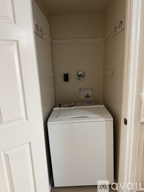 A small white bathroom with a toilet and a shower.