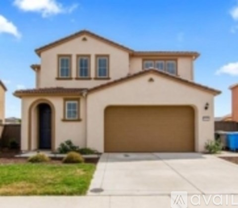 A beige house with a brown garage door.