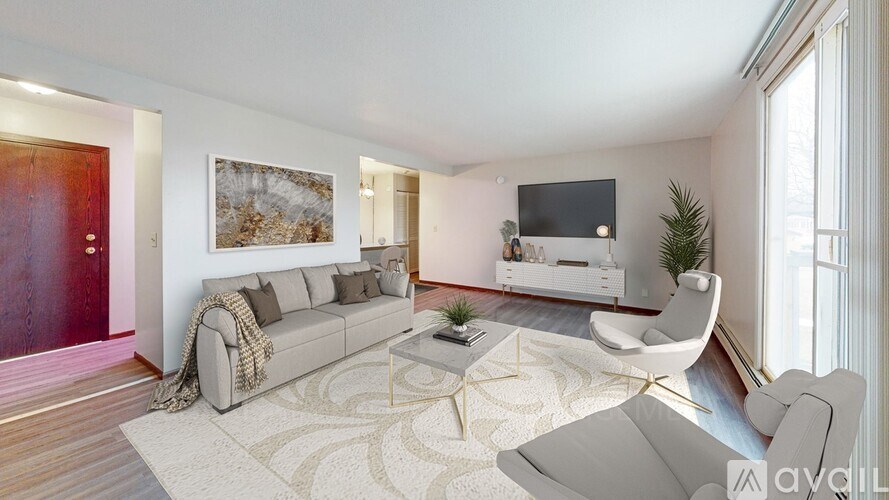 A living room with a grey sofa, a white chair, and a coffee table.