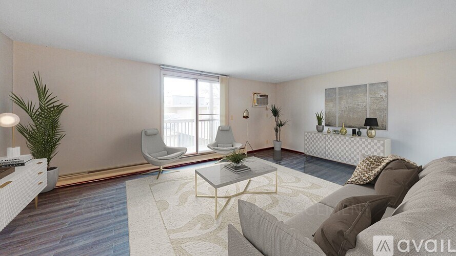 A living room with a grey couch and a white chair.