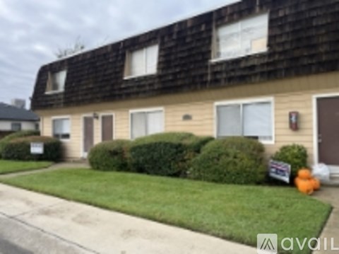 A building with a sign in front of it that says "available".