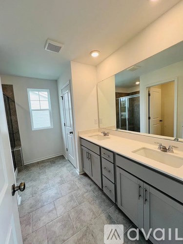 A bathroom with a sink, mirror, and tiled floor.