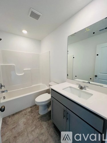 A bathroom with a toilet, sink, and bathtub.