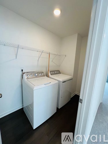 A laundry room with two washing machines and a clothesline.