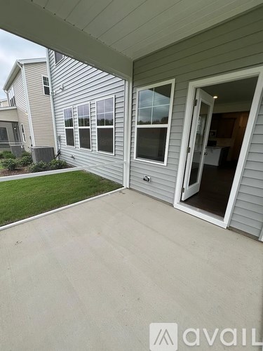 A house with a grey siding and a white door and window.
