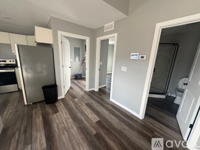 A kitchen with a refrigerator, oven, and sink.