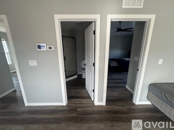 A room with a bed and a ceiling fan.