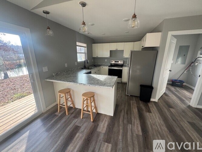 A kitchen with a bar stool and a countertop.