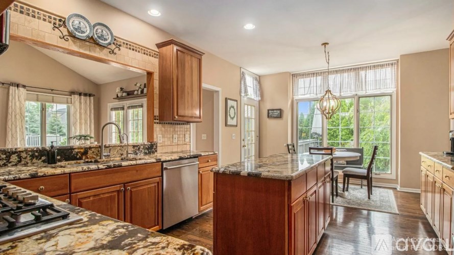 A kitchen with wooden cabinets and a marble countertop.