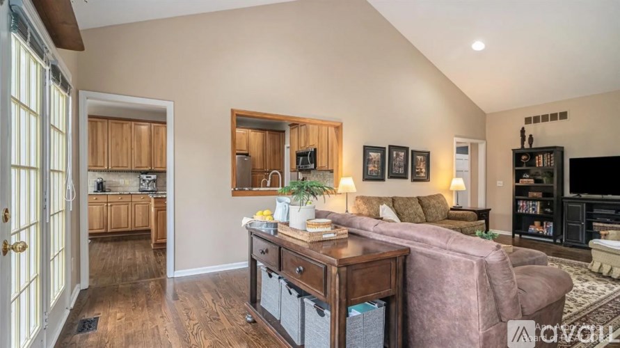 A living room with a couch, a coffee table, and a TV.