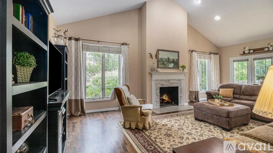 A living room with a fireplace and a chair.