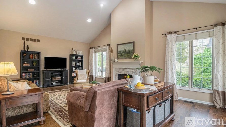 A cozy living room with a fireplace and a couch.