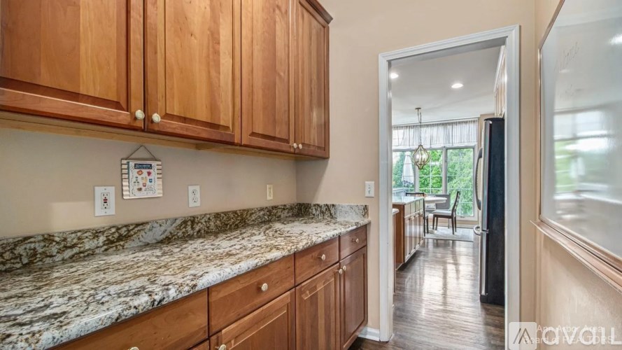 A kitchen with wooden cabinets and granite countertops.