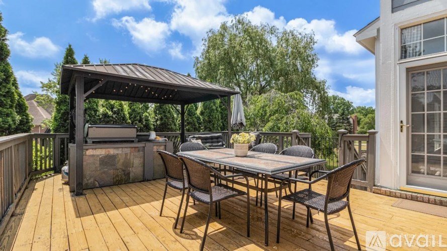 A patio with a table and chairs under a canopy.