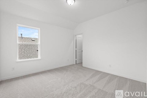 A room with a carpeted floor, a window with blinds, and a door.