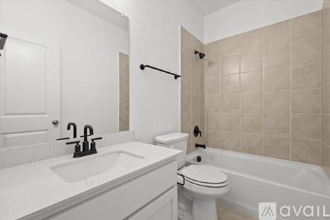 A bathroom with a white sink and toilet.