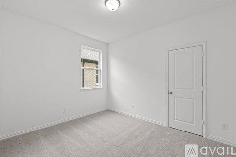 A white room with a door and a window.