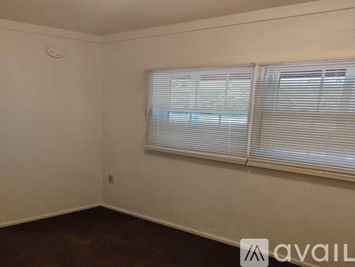 A room with a window covered in blinds.