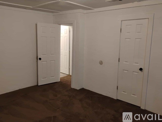 A room with two doors and a window.