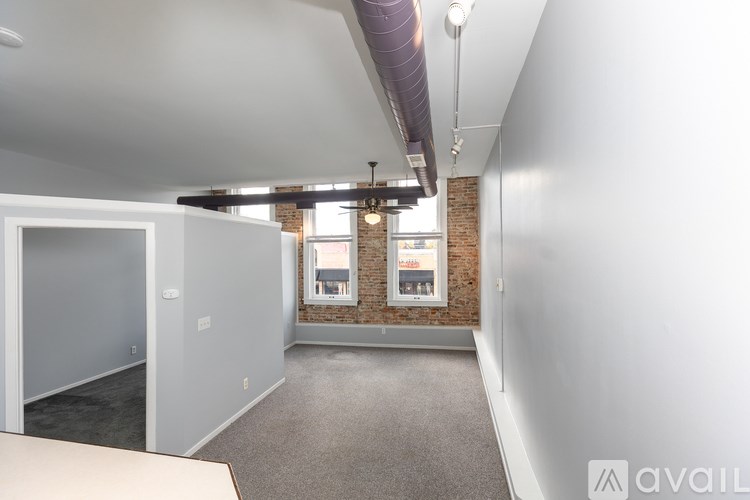 A room with a brick wall and a window.