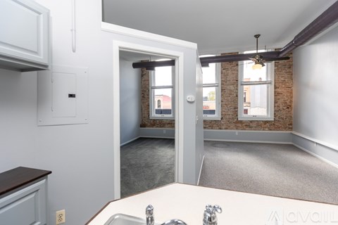 A kitchen with a sink and a window.