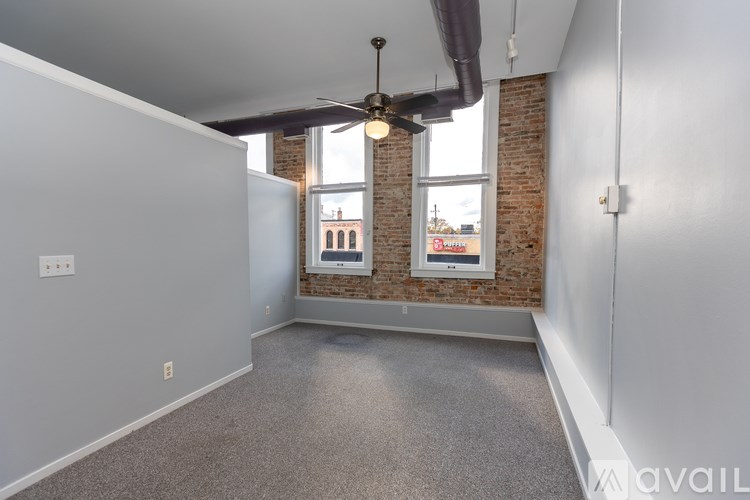 A room with a brick wall and a window.