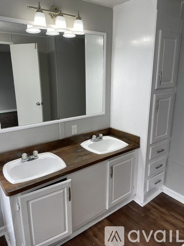 A bathroom with a white sink and a brown counter.