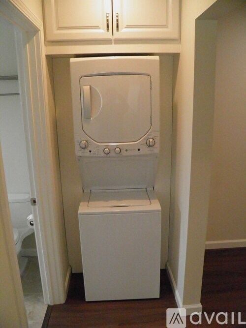 A white washing machine in a small room.