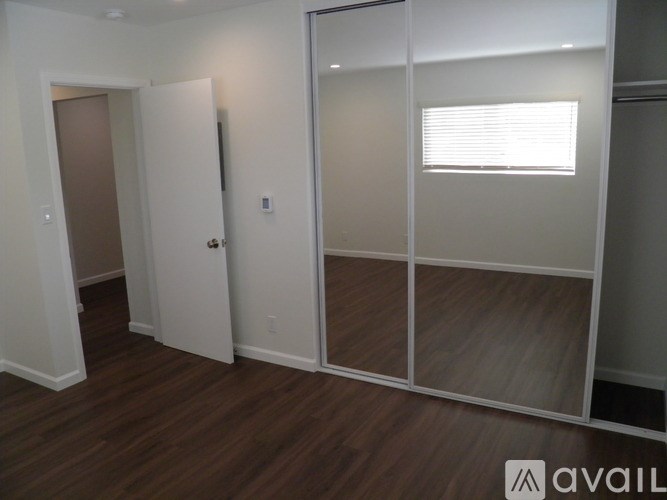 A room with a wooden floor and a glass wall.