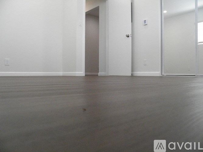 A room with a wooden floor and white walls.