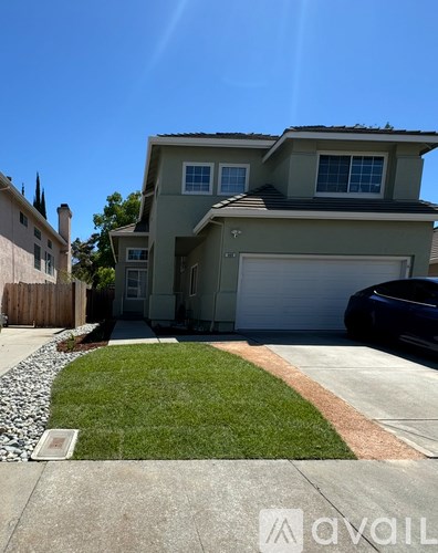 A house with a garage and a car parked in front.