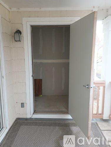 A white door with a glass window is open.