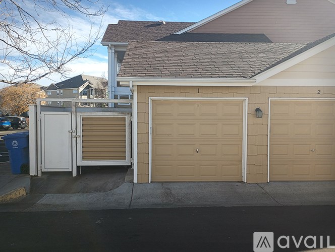 Two garage doors are closed and one is open.