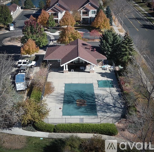 A house with a brown roof and a pool in the backyard.