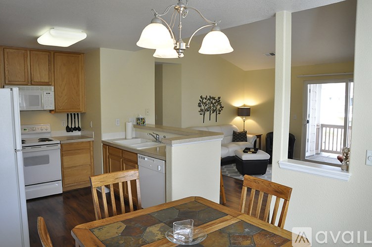 A kitchen with a table and chairs in the middle of the room.