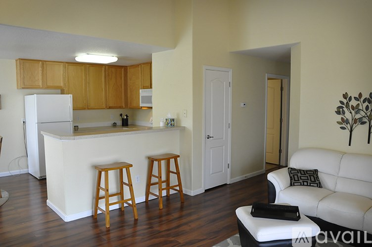 A kitchen with white appliances and wooden cabinets.
