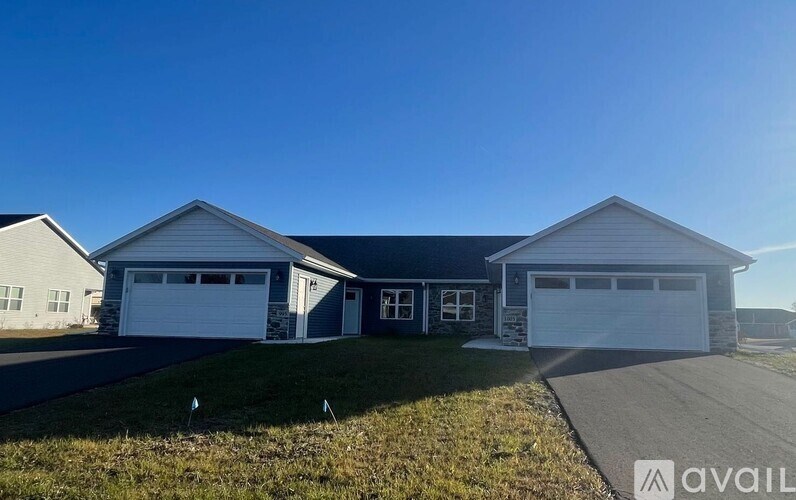 A two-story house with a garage is available for sale.