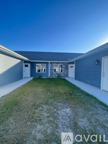 A two-story house with a garage and a driveway.