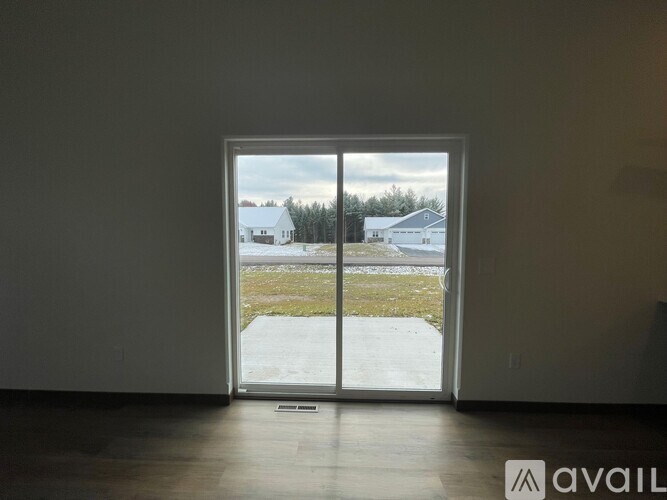 A staircase with a brown railing and beige steps leading to a door.