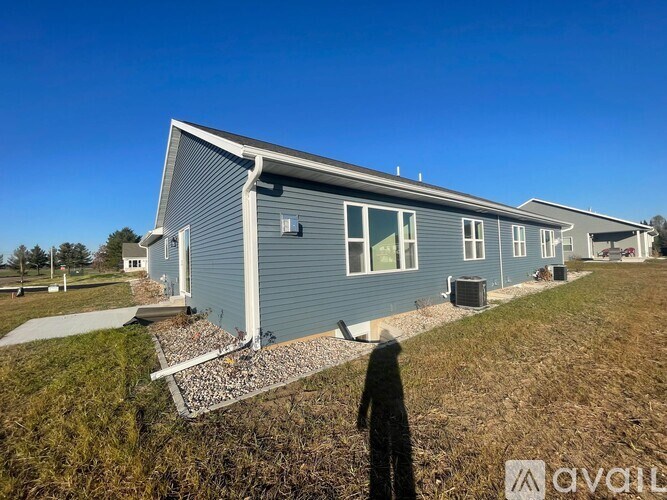 A grey house with a blue sky in the background.