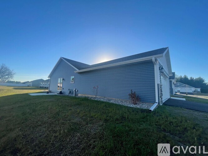 A house with a grey roof and a white door is available for purchase.