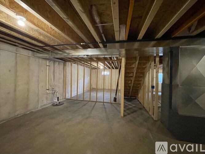 A room under construction with wooden beams on the ceiling.