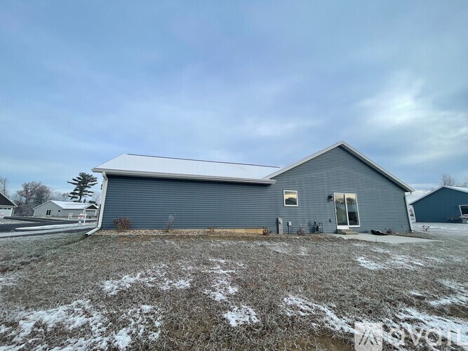 A two-story house with a garage and a driveway.