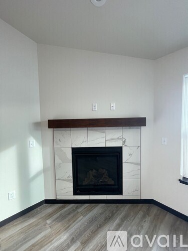 A room with a ceiling fan and carpeted floor.