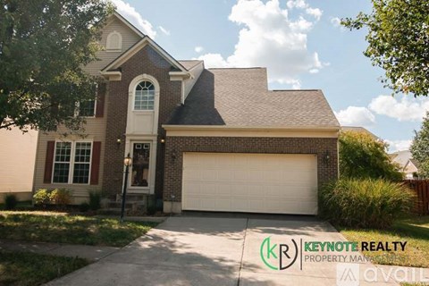 A house with a garage door is for sale.