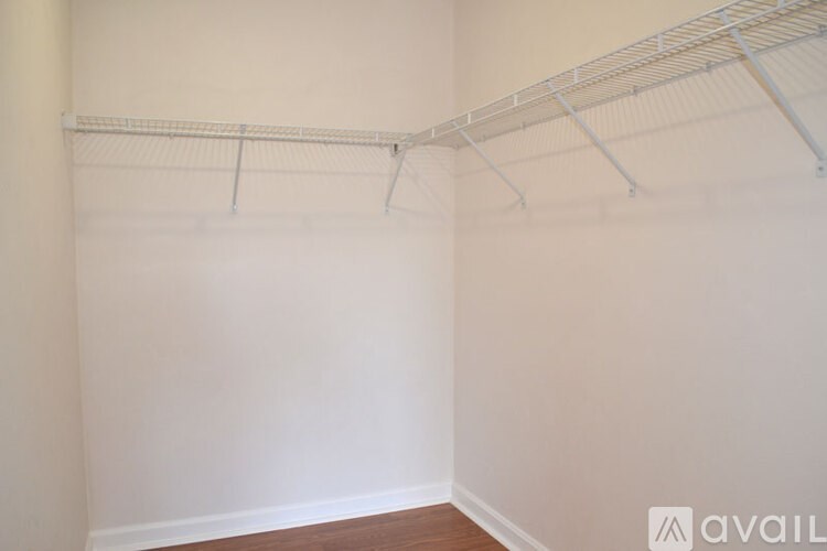 Empty room with a white wall and a white shelf.