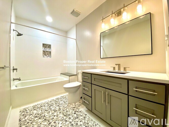 A bathroom with a tub, toilet, sink, and mirror.