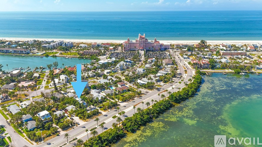 A bird's eye view of a coastal town with a large hotel in the center.