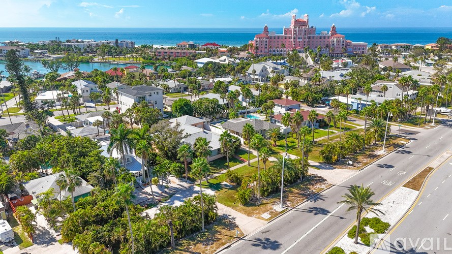A large building with a red roof is in the distance.