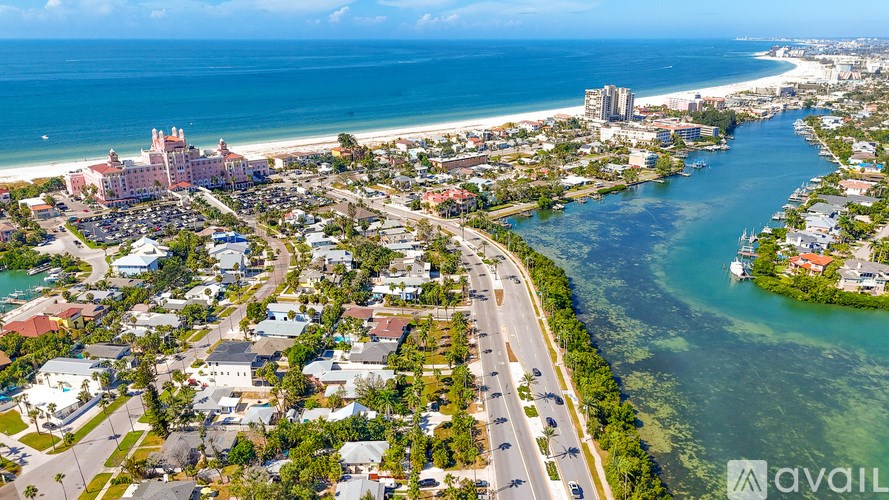 A bird's eye view of a coastal city with a river running through it.